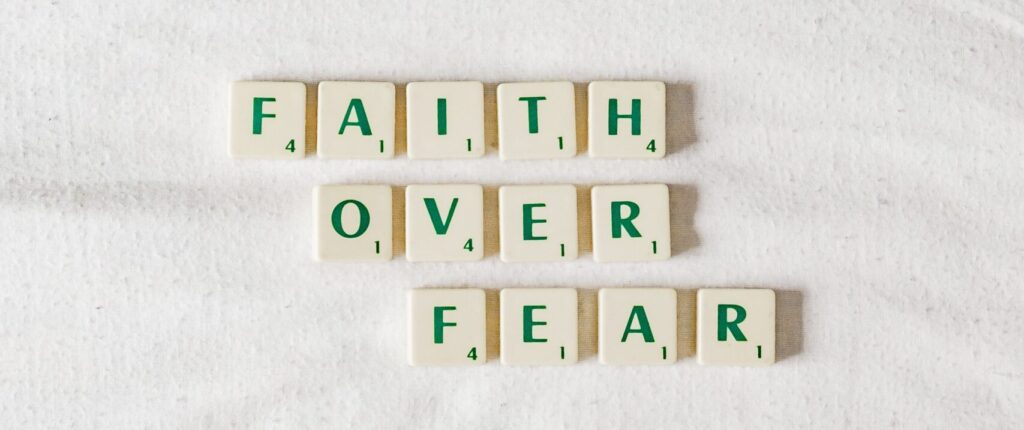 Faith Over Fear spelled out in scrabble tiles